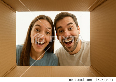 Joyful Couple Unboxing Surprise Together Home Photography Indoor Eye-Level Excitement and Anticipation 130574923