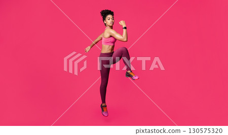 Slender fitness afro girl making work out, warming up body before training over red studio background Slender fitness afro girl making work out, warming up body before training over red studio background 130575320