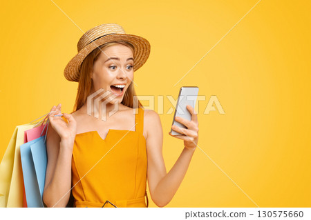 Discount App. Joyful Teen Girl In Straw Hat Looking At Smartphone Screen With Amazement Discount App. Joyful Teen Girl In Straw Hat Looking At Smartphone Screen With Amazement 130575660