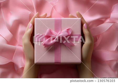 Woman hands holding pink gift satin ribbon, shopping Valentines, New Year, Mothers, Christmas Woman hands holding pink gift satin ribbon, shopping Valentines, New Year, Mothers, Christmas 130576103