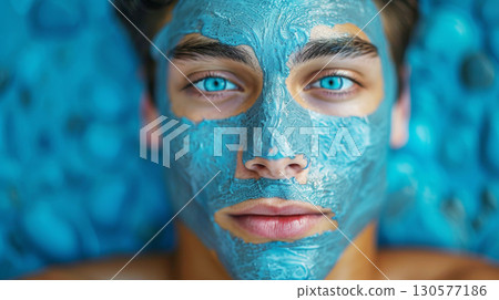 A man with a blue mask covering his face. 130577186