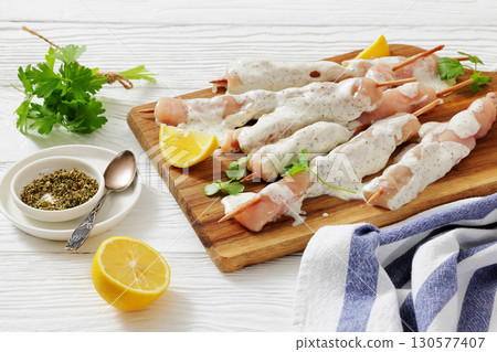 Greek style raw chicken souvlaki on a plate Greek style raw chicken souvlaki on a plate 130577407