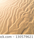 Textured Golden Sand Dunes Under Sunlight 130579621