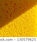Bright Yellow Porous Sponge Texture Close-Up 130579625