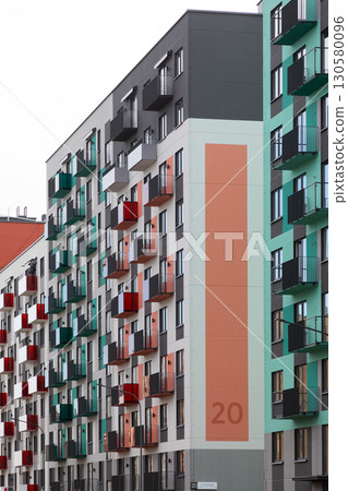 High-rise apartment buildings in a residential area with varied balcony colors and modern 130580096