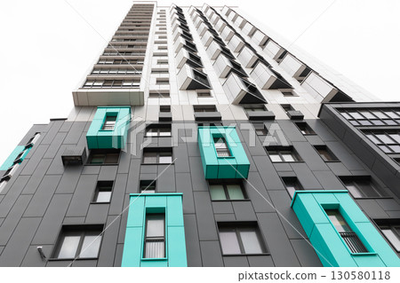 Modern high-rise apartment buildings in a vibrant residential area showcasing unique architectural 130580118
