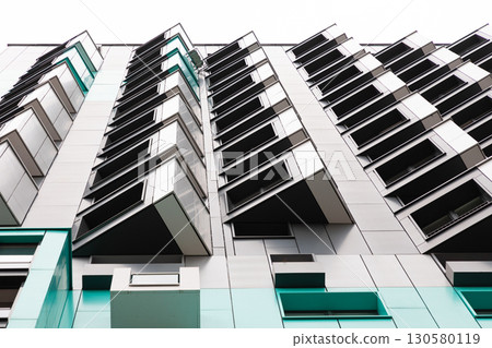 High-rise apartment buildings in a residential area with modern architecture and unique balcony 130580119