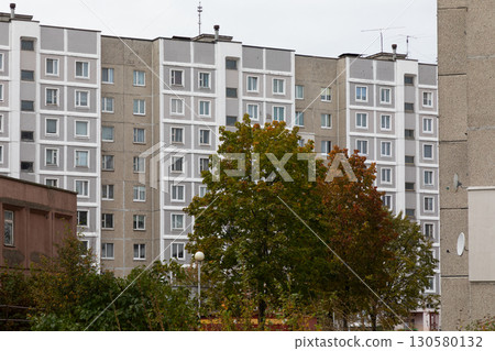High-rise apartment buildings in a residential area with green trees, highlighting aspects of urban High-rise apartment buildings in a residential area with green trees, highlighting aspects of urban 130580132