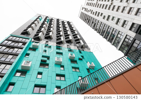 High-rise apartment buildings in a modern residential area showcasing contemporary architecture and High-rise apartment buildings in a modern residential area showcasing contemporary architecture and 130580143