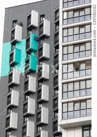 Modern high-rise apartment buildings in a residential area showcasing unique architectural designs 130580182