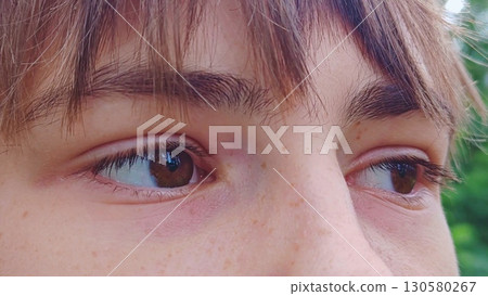 Men's eyes, looking thoughtfully. close-up of a young guy's eyes. guy looks away 130580267