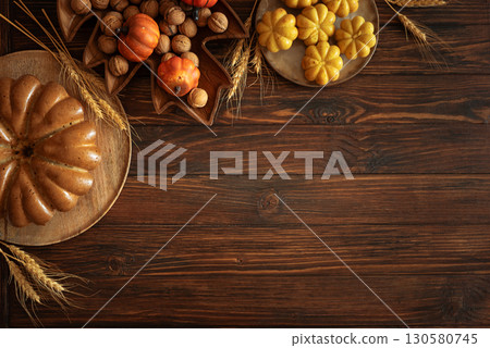 Autumn Harvest Table with Bundt Cake, Pumpkin Cookies and Seasonal Decor 130580745
