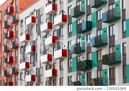 Vibrant residential high-rise buildings showcasing modern architecture in a bustling urban area with 130581069
