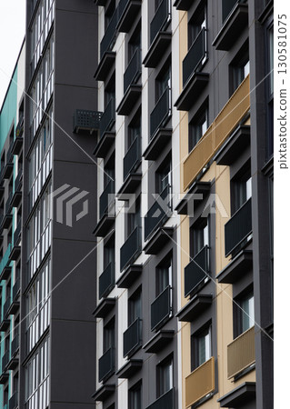 High-rise apartment buildings in a residential area showcasing diverse designs and accommodations High-rise apartment buildings in a residential area showcasing diverse designs and accommodations 130581075