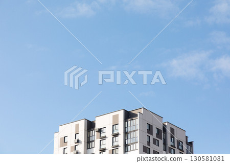 Modern high-rise apartment buildings under a blue sky in a bustling residential area focused on Modern high-rise apartment buildings under a blue sky in a bustling residential area focused on 130581081