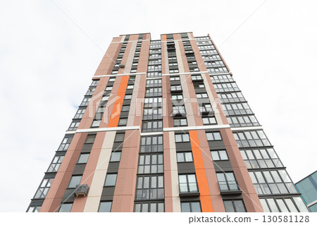 High-rise apartment building in a residential area showcasing modern architecture and potential 130581128