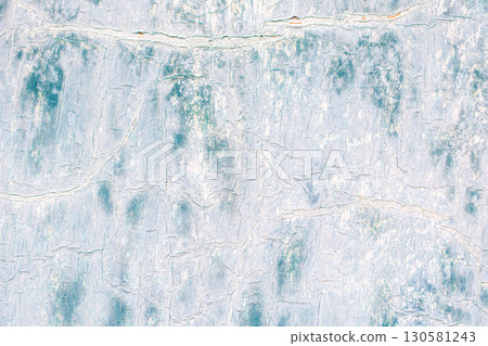 Macro fragment of an old surface with cracked paint structure. Texture of a metal sheet painted white and blue. Multilayered, worn surface. Macro fragment of an old surface with cracked paint structure. Texture of a metal sheet painted white and blue. Multilayered, worn surface. 130581243