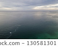 Calm sea horizon under cloudy sky 130581301