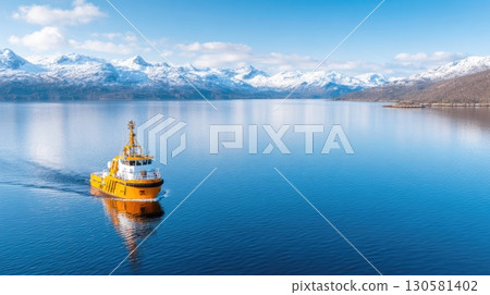 Yellow tugboat on fjord 130581402