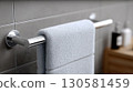Gray Towel on Chrome Rack in Bathroom 130581459