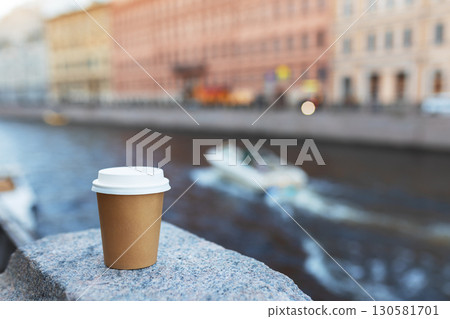 paper cup of drink on bridge near river with ship in St. Petersburg, copy space paper cup of drink on bridge near river with ship in St. Petersburg, copy space 130581701