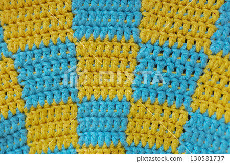 crochet yellow and blue squares in checkerboard pattern background crochet yellow and blue squares in checkerboard pattern background 130581737