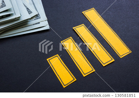 Growing chart with cash nearby. Personal savings. 130581851