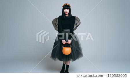 A simple background photo of a woman standing in a fairy costume 130582005