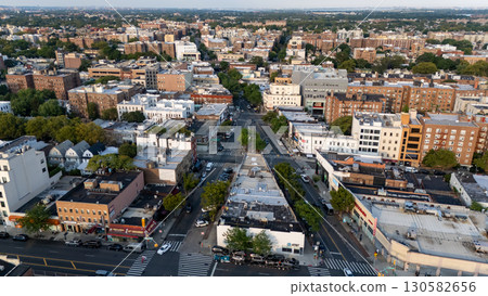 Busy city street with colorful market stalls, bustling shoppers, and cars lining Busy city street with colorful market stalls, bustling shoppers, and cars lining 130582656