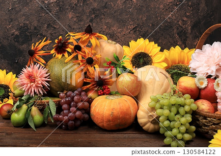Autumn background with seasonal nature autumn berries, pumpkins, apples, grapes, melons and flowers on old background, copy space, Happy Thanksgiving concept Autumn background with seasonal nature autumn berries, pumpkins, apples, grapes, melons and flowers on old background, copy space, Happy Thanksgiving concept 130584122