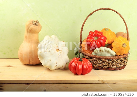 A variety of selection pumpkins, squash and tomatoes on a wooden table. Autumn composition with gifts of nature, thanksgiving day concept, harvesting, banner or splash, postcard, A variety of selection pumpkins, squash and tomatoes on a wooden table. Autumn composition with gifts of nature, thanksgiving day concept, harvesting, banner or splash, postcard, 130584130