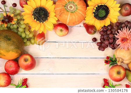 Autumn background with apples, pears, pumpkins, grapes, melons, sunflower flowers, plums on a wooden table, Thanksgiving concept, rustic harvest, Autumn background with apples, pears, pumpkins, grapes, melons, sunflower flowers, plums on a wooden table, Thanksgiving concept, rustic harvest, 130584176