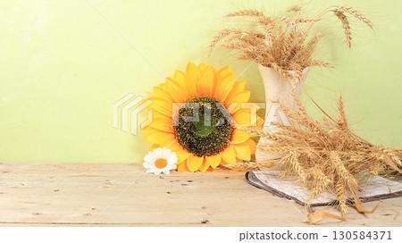 Thanksgiving background, harvest concept, autumn composition with sunflower flowers and ears of wheat and rye on a light background, rustic style, selective focus, place for text 130584371