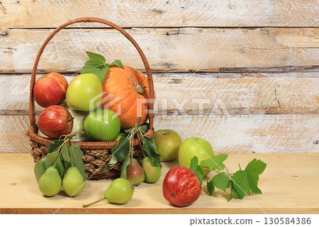 Autumn background with apples, pears, pumpkins, melons and plums in baskets on a wooden table, Thanksgiving concept, rustic harvest, healthy natural food concept, screen banner, 130584386