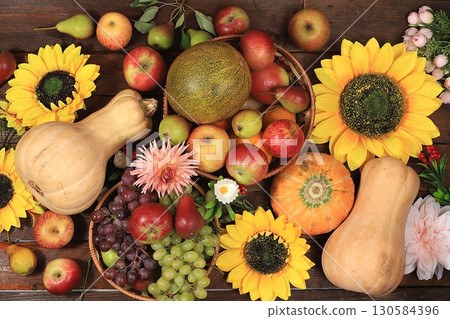 Happy Thanksgiving concept, autumn background with seasonal fall nature berries, pumpkins, melons, apples, grapes and flowers on wooden background, top view, copy space, flat lay. , selective focus. Happy Thanksgiving concept, autumn background with seasonal fall nature berries, pumpkins, melons, apples, grapes and flowers on wooden background, top view, copy space, flat lay. , selective focus. 130584396