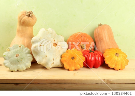 A variety of selection pumpkins, squash and tomatoes on a wooden table. Autumn composition with gifts of nature, thanksgiving day concept, harvesting, banner or splash, postcard, rustic style, A variety of selection pumpkins, squash and tomatoes on a wooden table. Autumn composition with gifts of nature, thanksgiving day concept, harvesting, banner or splash, postcard, rustic style, 130584401