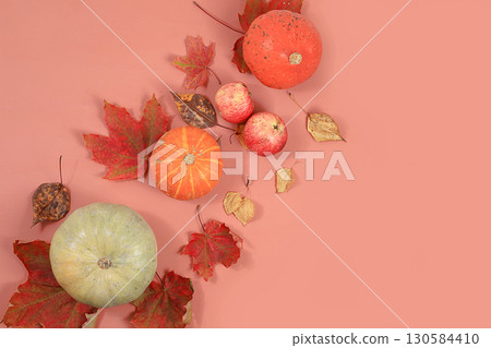 Happy Thanksgiving minimal concept, postcard, autumn composition with seasonal leaves, pumpkins, apples on pastel background, selective focus, flat lay, place for text 130584410