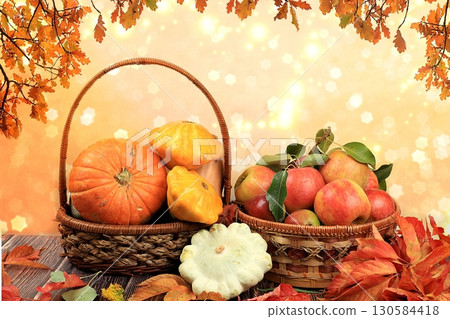 Basket with pumpkins, squash and apples on a wooden table. Autumn abstract composition with oak leaves on blurred bokeh background, thanksgiving day concept, banner or splash, postcard, Basket with pumpkins, squash and apples on a wooden table. Autumn abstract composition with oak leaves on blurred bokeh background, thanksgiving day concept, banner or splash, postcard, 130584418