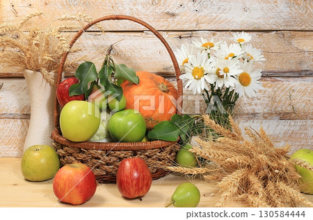 Autumn background with seasonal berries, melons, pears, cucumbers, wheat, apples and flowers on a wooden background. Happy Thanksgiving concept, copy space, healthy and natural food, selective focus. Autumn background with seasonal berries, melons, pears, cucumbers, wheat, apples and flowers on a wooden background. Happy Thanksgiving concept, copy space, healthy and natural food, selective focus. 130584444
