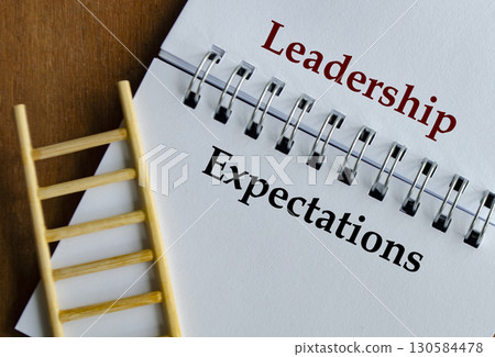 Notepad with clear text Leadership Expectations placed on desk with ladder visual support. 130584478