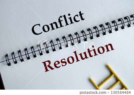 Conflict Resolution, Notepad with the bold words Conflict Resolution written across its white lined sheet on a desk. 130584484