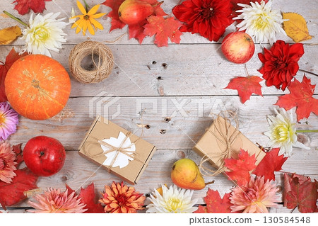 Happy Thanksgiving concept, postcard Autumn background with seasonal pears, pumpkins, apples and flowers on wooden background, copy space, selective focus. Harvesting, gifts of nature Happy Thanksgiving concept, postcard Autumn background with seasonal pears, pumpkins, apples and flowers on wooden background, copy space, selective focus. Harvesting, gifts of nature 130584548