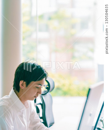 Man sitting at desk Man sitting at desk 130584635