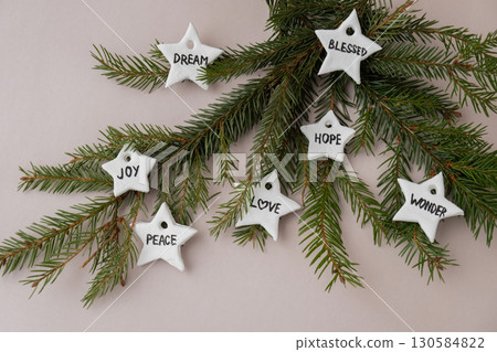 Christmas star with words RISEN BLESSED HOPE JOY PEACE DREAM LOVE WONDER White air dry clay for making decor to Christmas tree holiday. Creating hobby recreation activity that involves fingers. DIY Christmas star with words RISEN BLESSED HOPE JOY PEACE DREAM LOVE WONDER White air dry clay for making decor to Christmas tree holiday. Creating hobby recreation activity that involves fingers. DIY 130584822