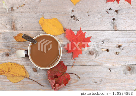 Autumn drink, seasonal composition, hot coffee with cinnamon in iron mugs on wooden background, copy space, Happy thanksgiving concept, greeting card, flat lay 130584898