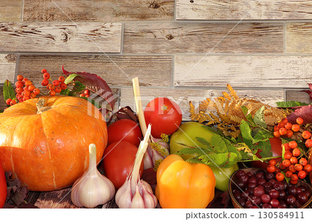 Autumn background and harvest in the village with seasonal berries, pumpkins, cranberries, rowan, tomatoes and nature flowers . Happy Thanksgiving concept, Autumn background and harvest in the village with seasonal berries, pumpkins, cranberries, rowan, tomatoes and nature flowers . Happy Thanksgiving concept, 130584911