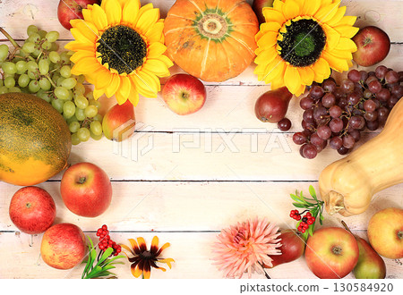 Thanksgiving background, harvest concept, autumn composition with fruits, nature berries, watermelons, melons, wheat, apples, flowers and ears of wheat and rye Thanksgiving background, harvest concept, autumn composition with fruits, nature berries, watermelons, melons, wheat, apples, flowers and ears of wheat and rye 130584920
