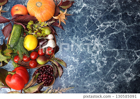 Autumn background with seasonal berries, pumpkins, apples, tomatoes and flowers of autumn nature on wooden boards, copy space, flat lay. Happy Thanksgiving concept, selective focus. 130585091