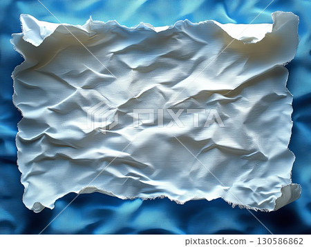 Crumpled white paper sheet on blue background creating a texture 130586862