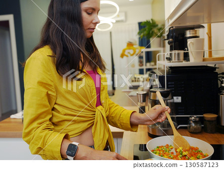 Young woman is broadcasting live from workshop how to prepare a vegetarian food Young woman is broadcasting live from workshop how to prepare a vegetarian food 130587123